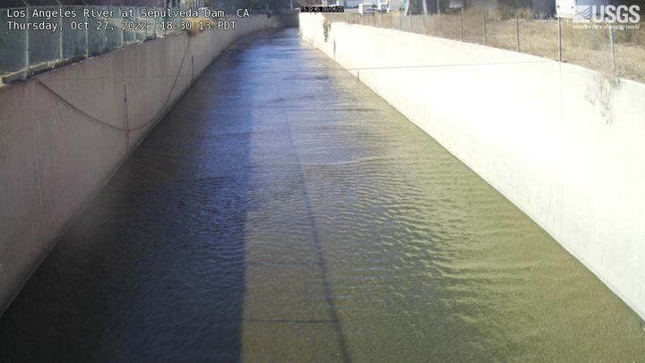 view looking down the length of a concrete-lined Los Angeles River