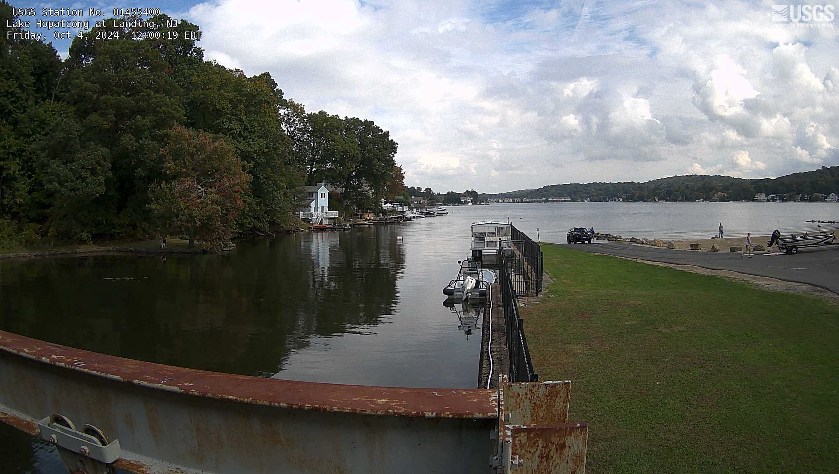 Looking out along a grass covered pier in the lake beyond