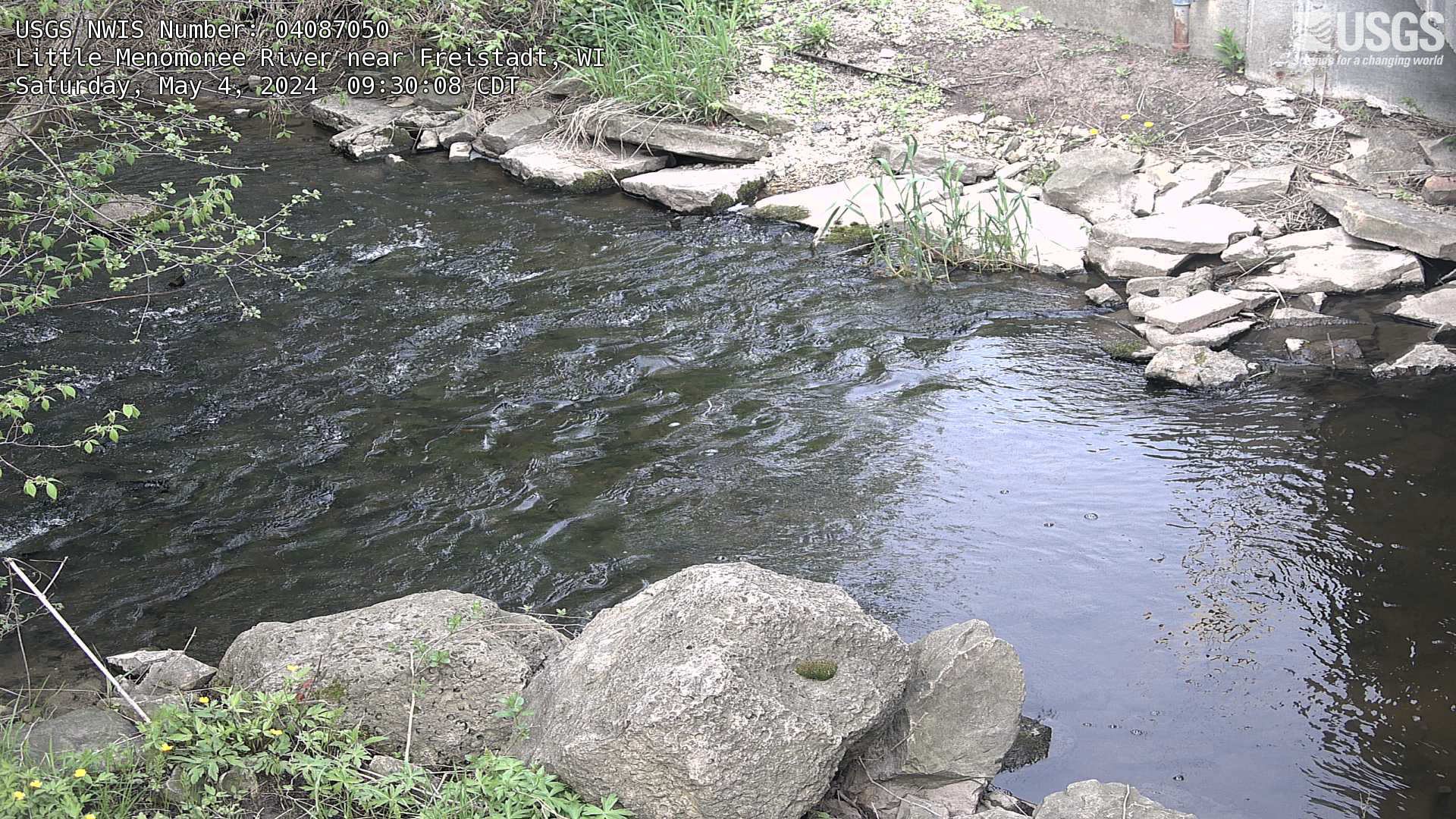 Closeup view of a river, rocky areas on either side.